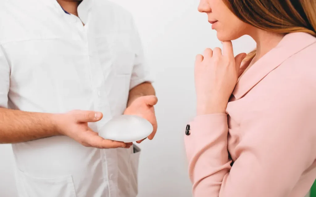 Clinician and woman in a pink blazer discussing options during a consultation