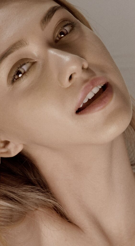 Close-up portrait of a woman with clear, smooth skin and natural makeup